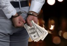 side view man in handcuffs holding money arrested 38618 48 14 359 640x360 1